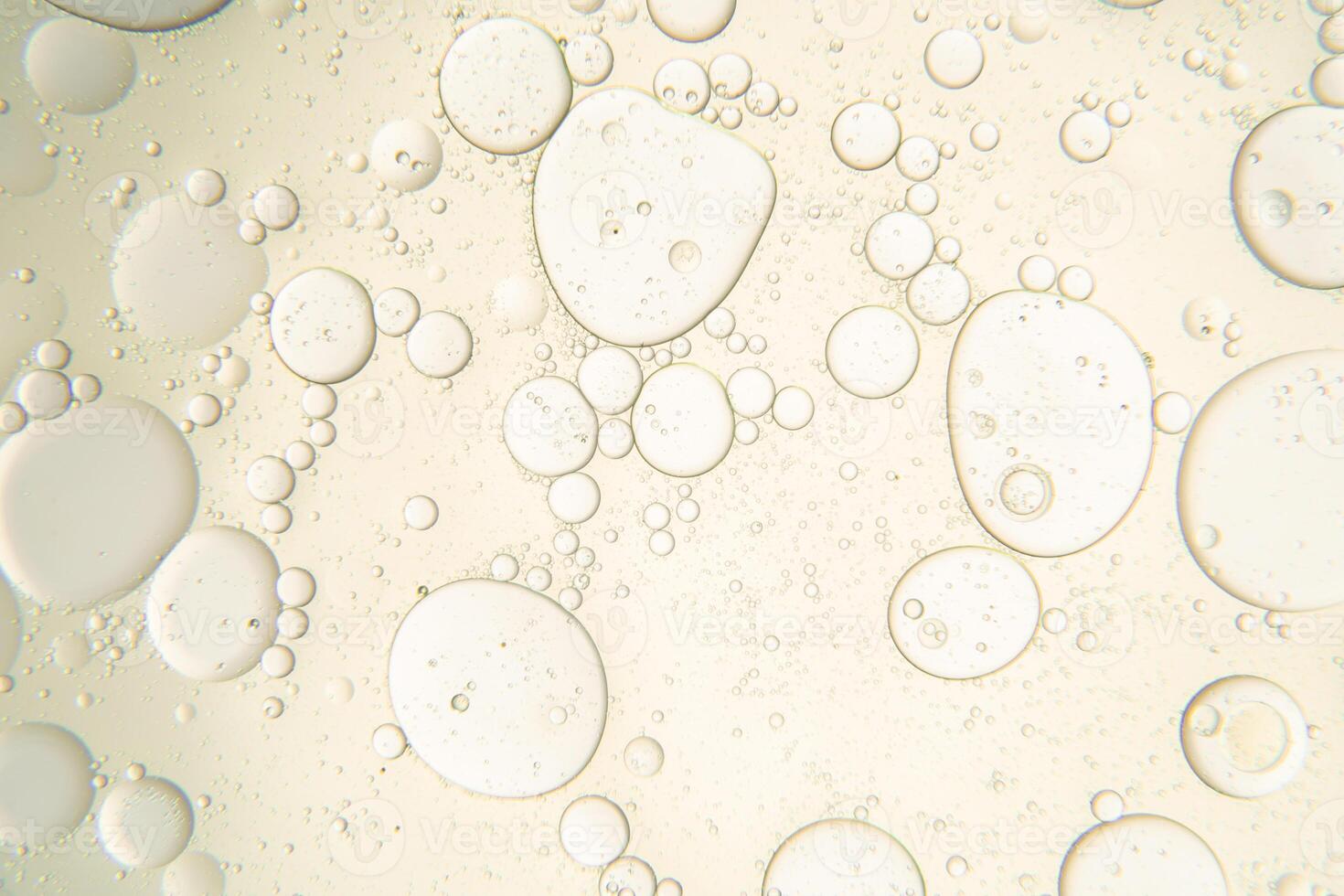 Abstract composition with water and oil drops against white background photo