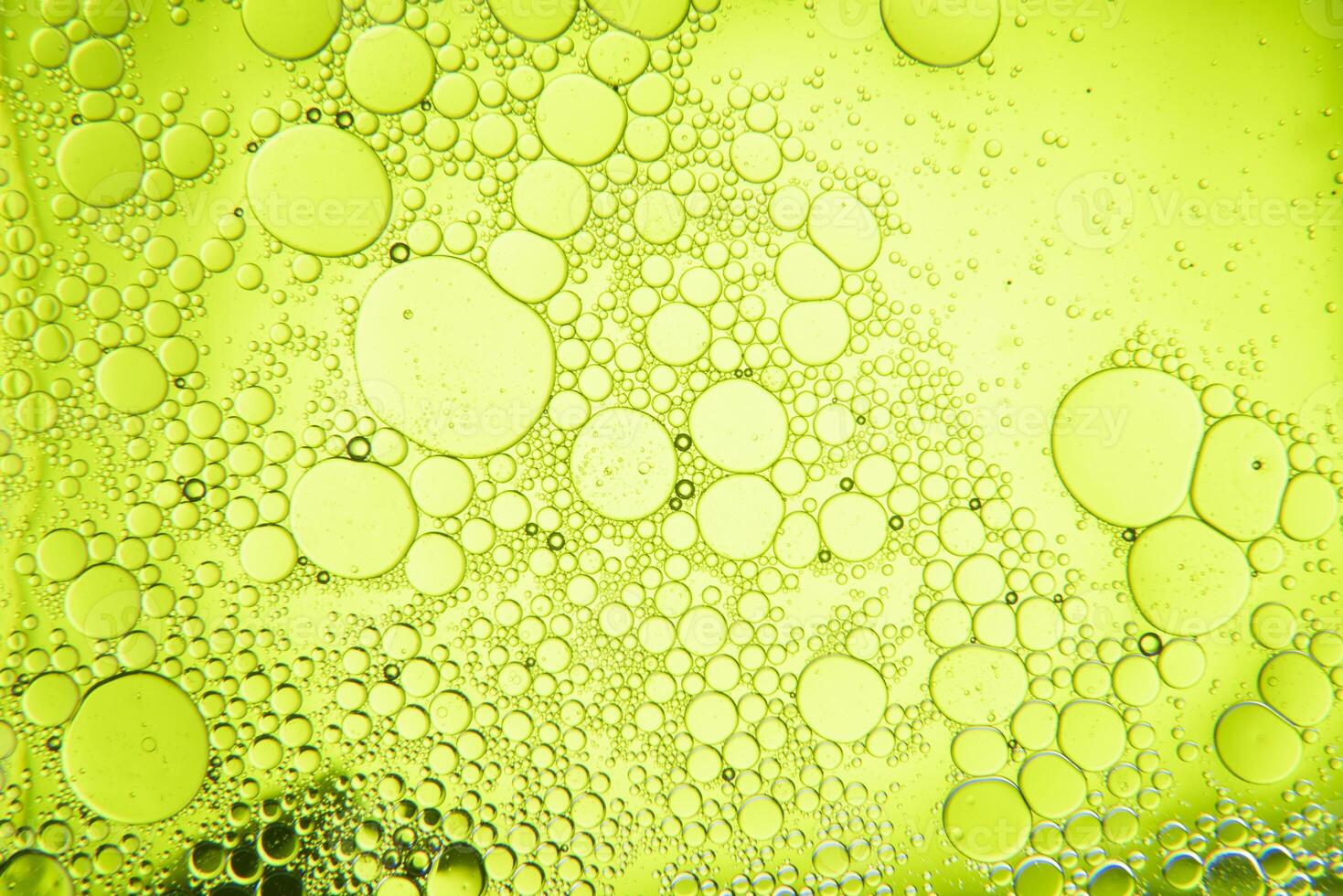 Abstract composition with water and oil drops against green background photo