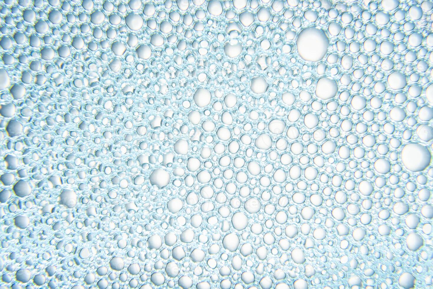 Texture of soap bubbles with water with blue light photo