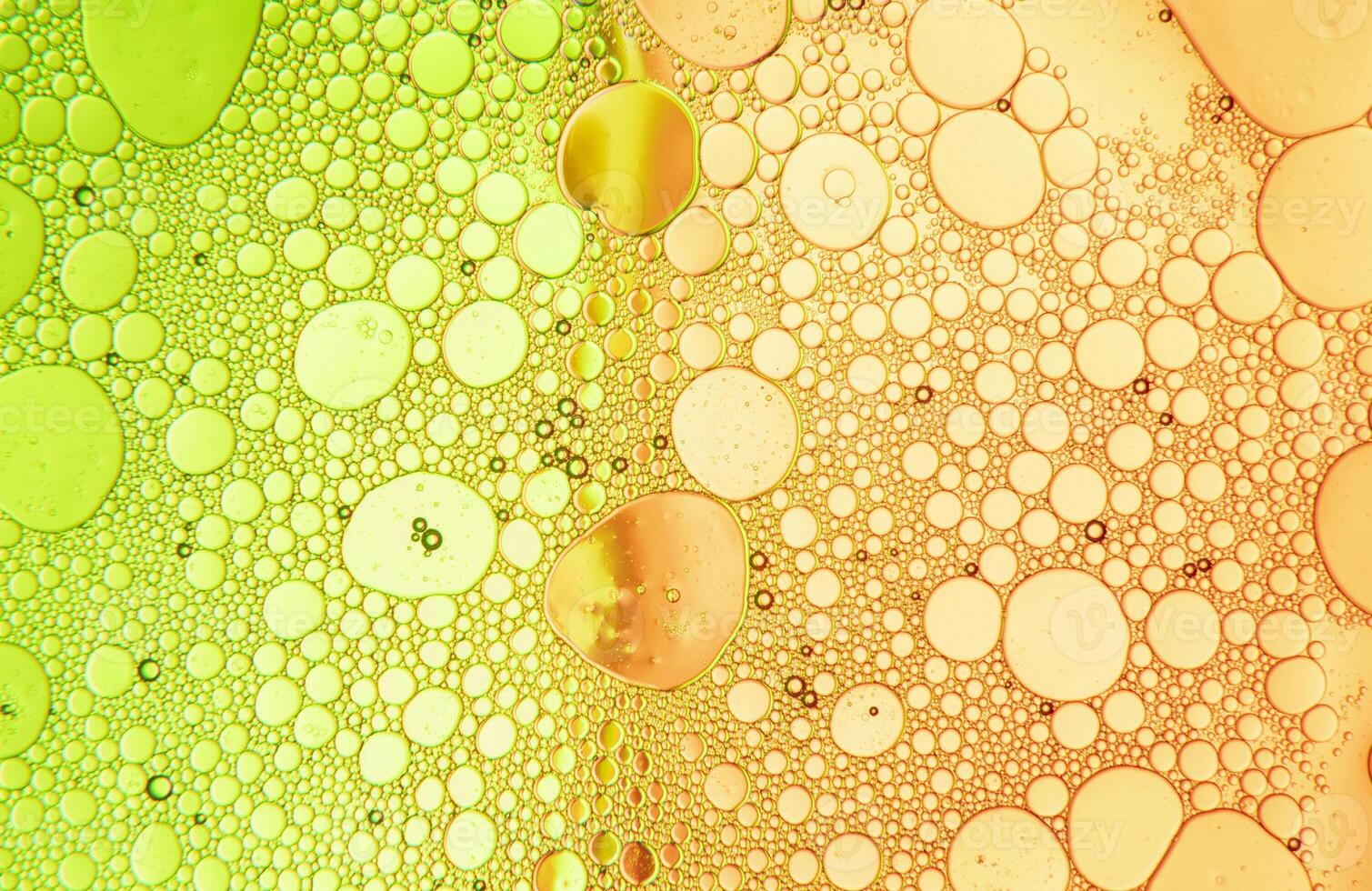 Abstract composition with water and oil drops against green and orange background photo