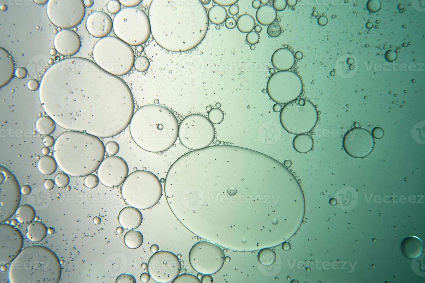 Abstract composition with water and oil drops against white and green background photo