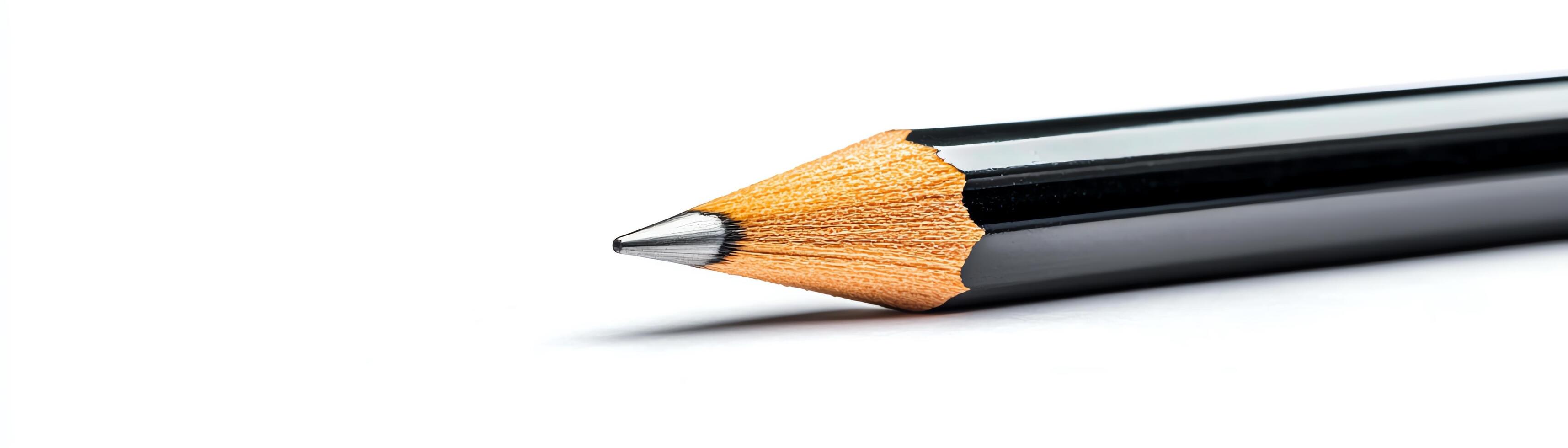 Close-up of a black pencil on a white background, ideal for design. photo