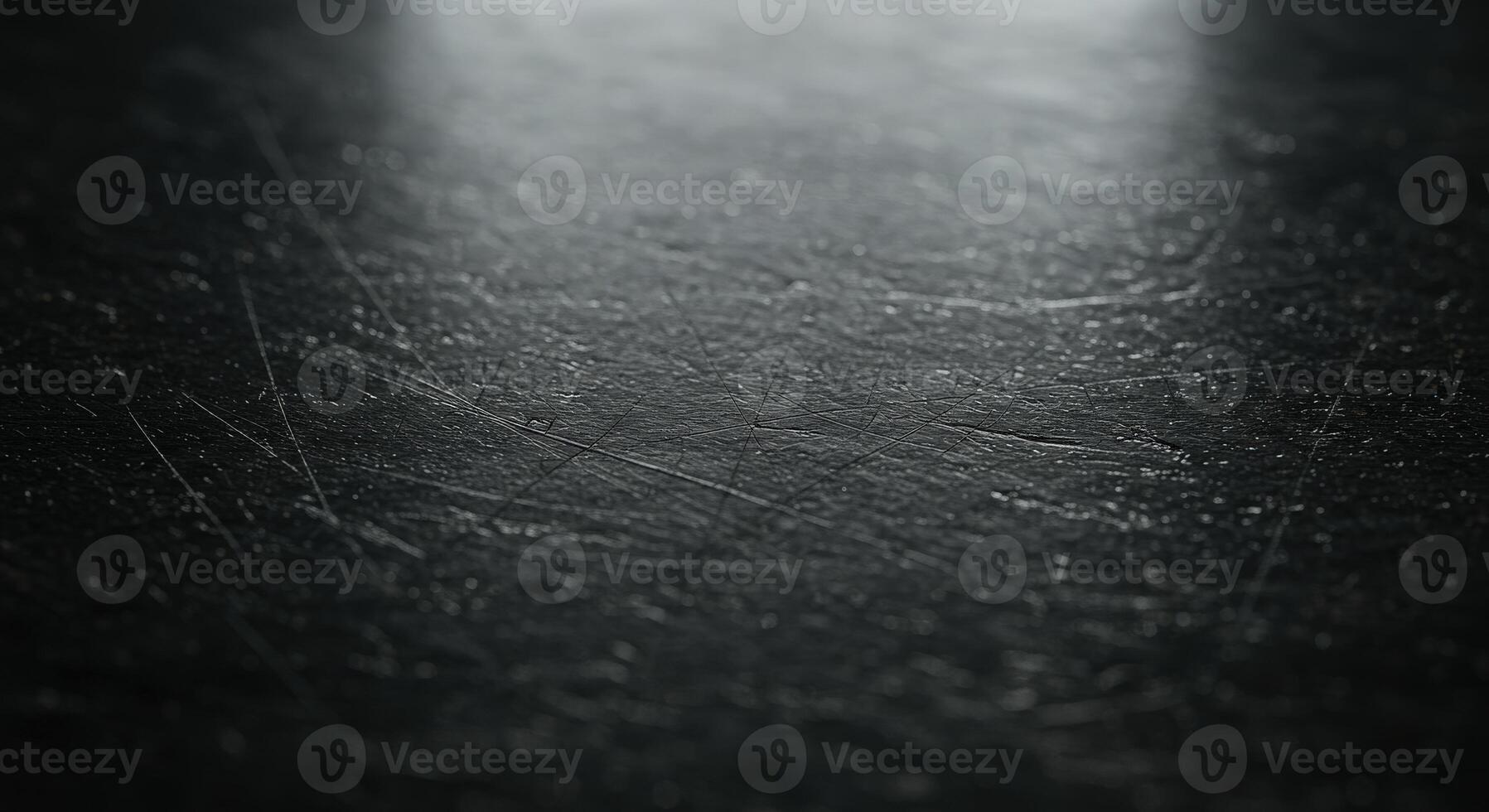 A black surface with a light shining on it photo