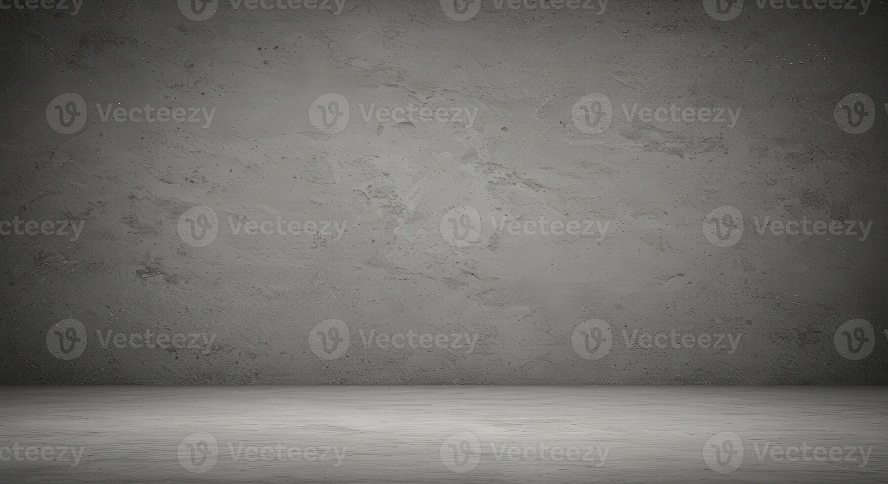 An empty room with a concrete wall and a cement floor photo