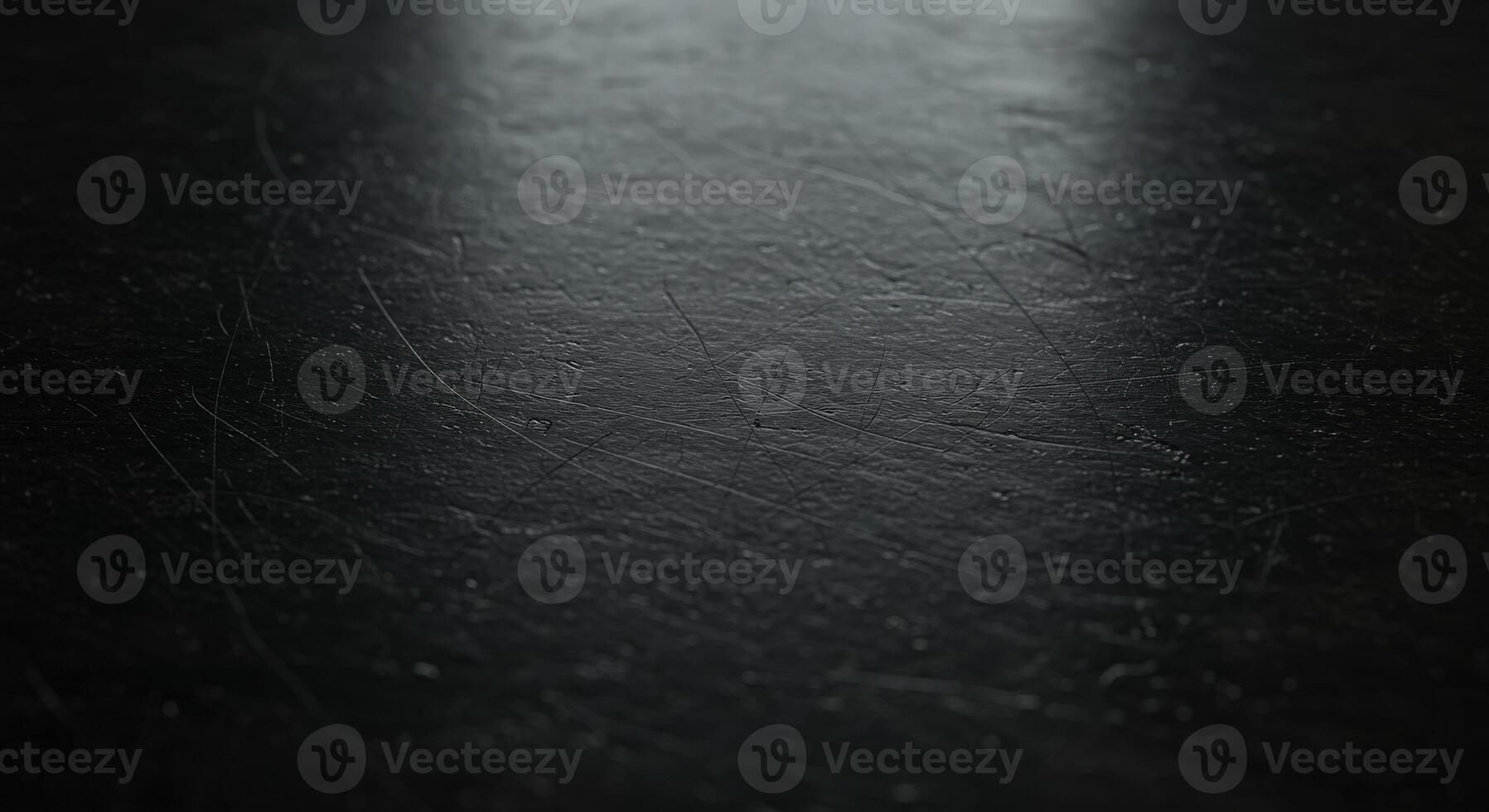 A black surface with a light shining on it photo