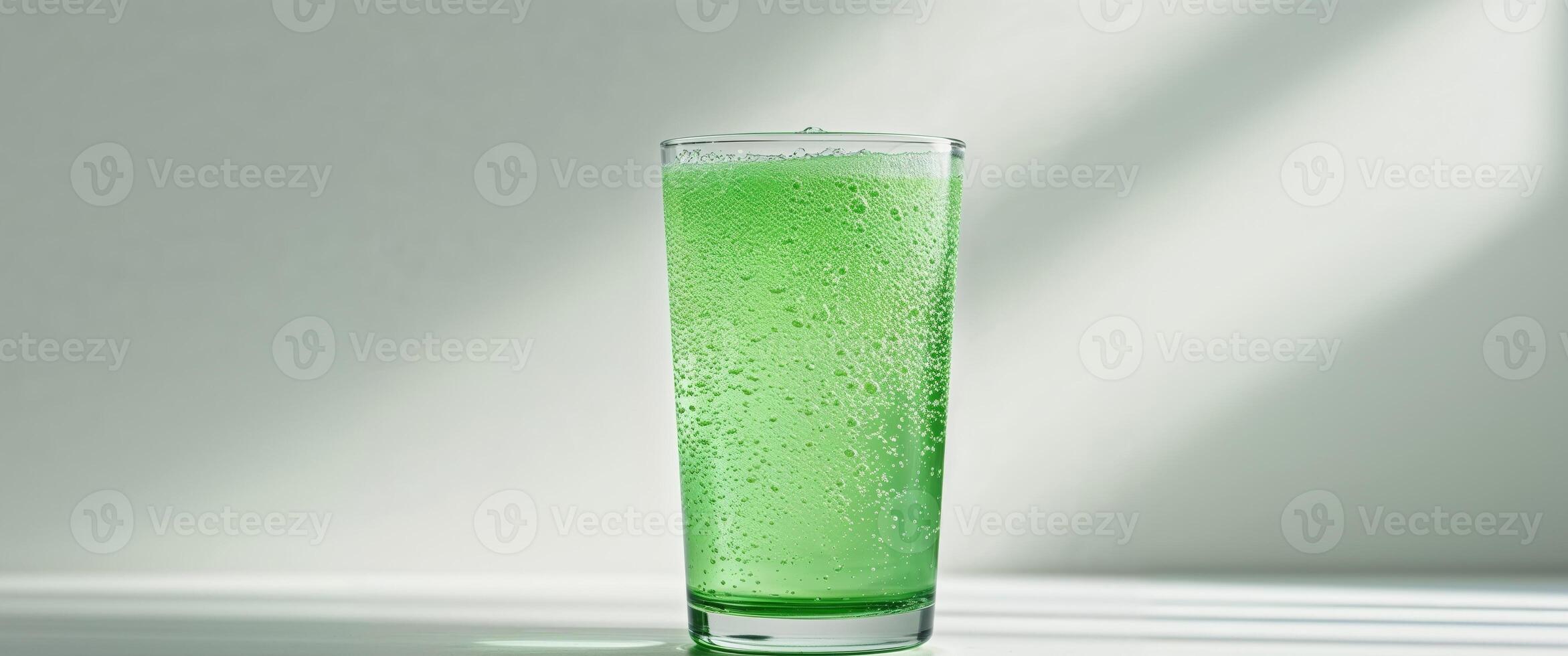 Glass of lime soda with fizzy carbonation photo