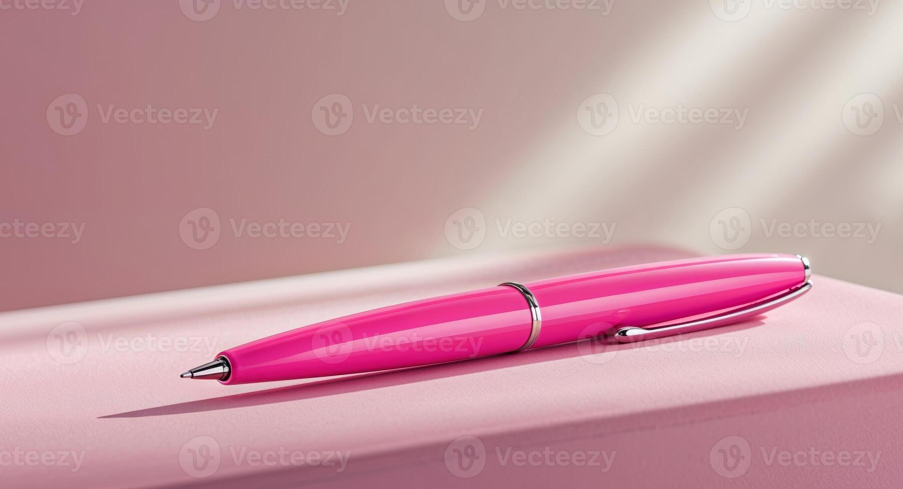 Bright Pink Pen on Smooth Pink Surface for Office Use and Creativity. photo
