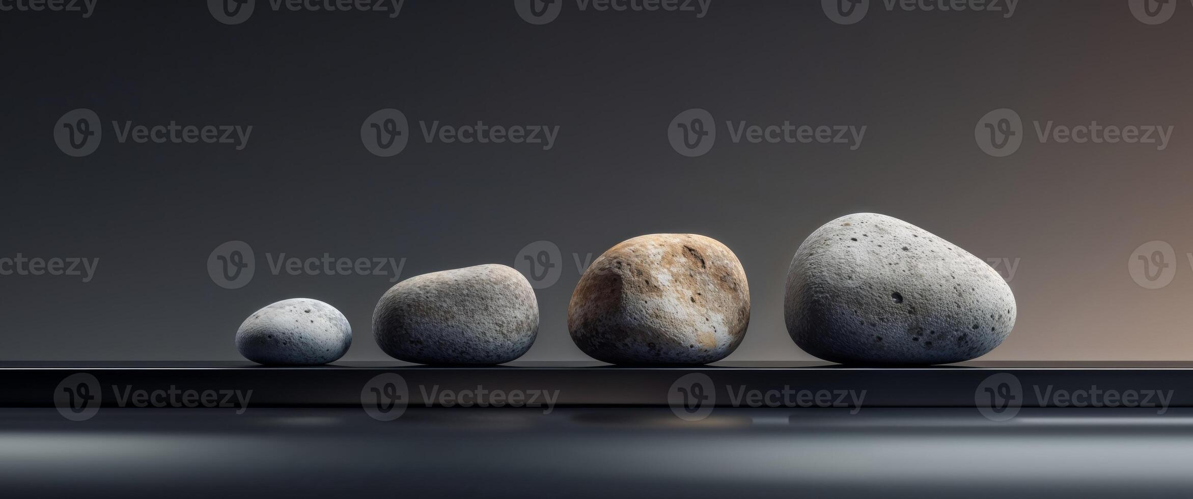 Four rocks are arranged in a row on a table photo