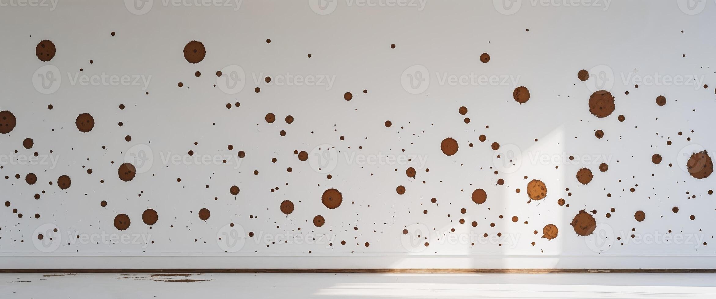 A room with a white wall and brown dots on it photo