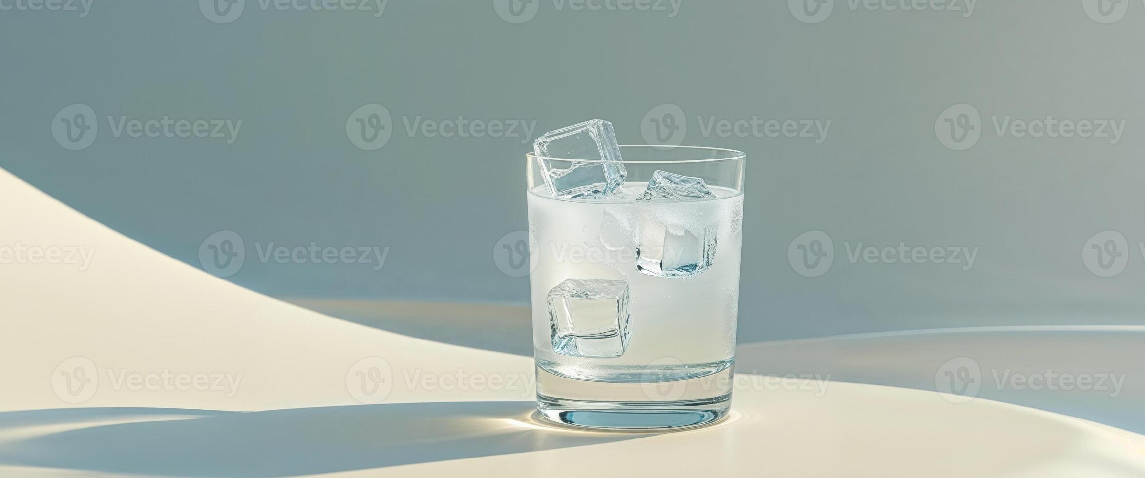 Extreme closeup of a refreshing drink with ice in a clear glass on a clean surface photo