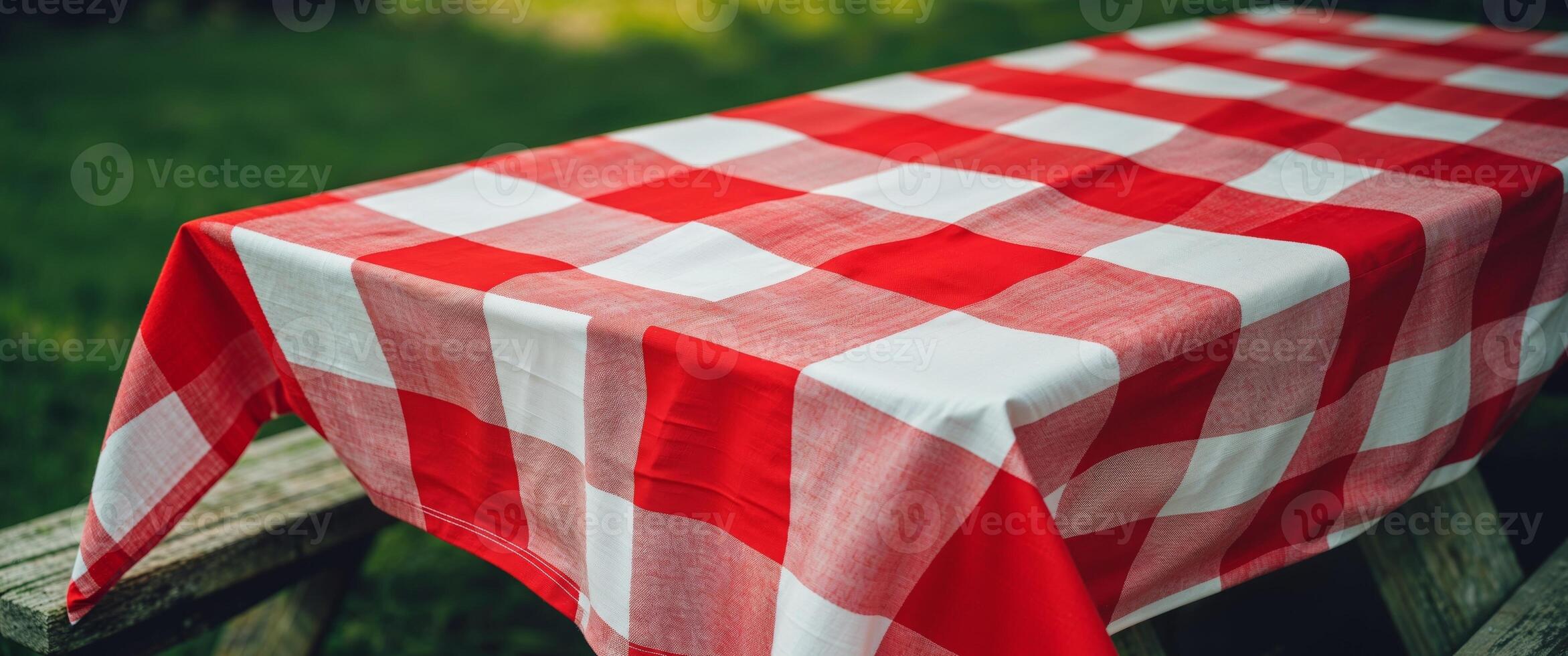 Bright red and white checkered tablecloth for outdoor picnics and gatherings. photo