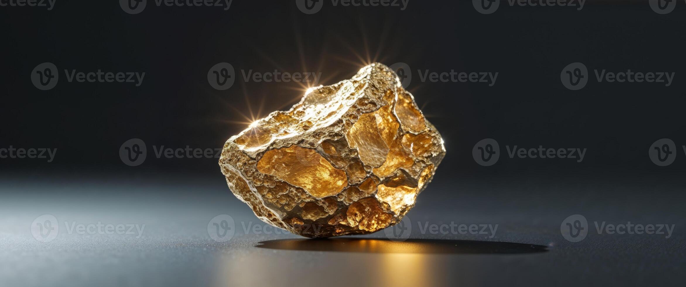 Exquisite gold nugget on dark reflective surface photo