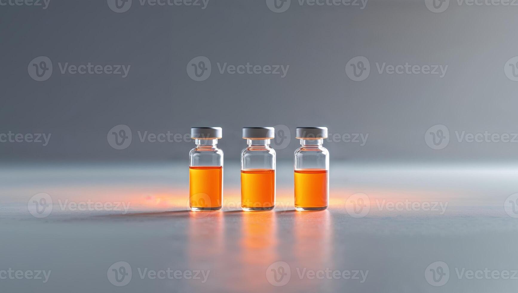Three Glass Laboratory Vials with Orange Liquid on Table Surface. photo
