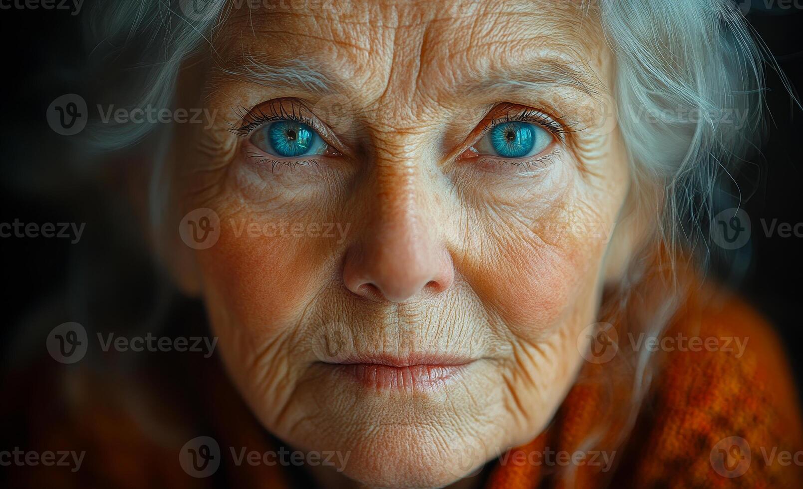 A woman with blue eyes and a red sweater. She has a serious expression on her face. Concept of loneliness and sadness photo