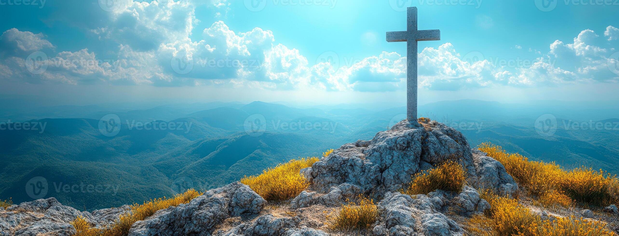 A cross is on top of a mountain, with a blue sky in the background. Concept of peace and serenity, as the cross stands tall and proud on the rocky hill. The combination of the natural landscape photo