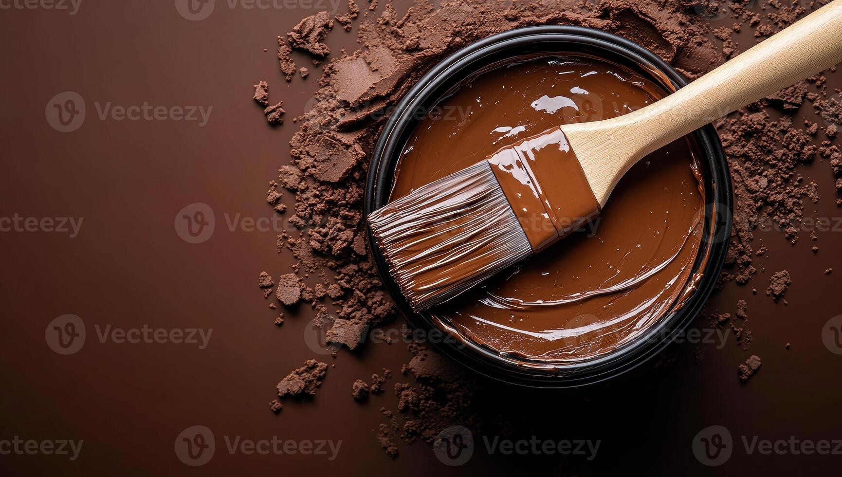 A wooden paintbrush is dipped into a bowl of chocolate. The chocolate is thick and rich, and the brush is covered in it. Concept of indulgence and pleasure photo
