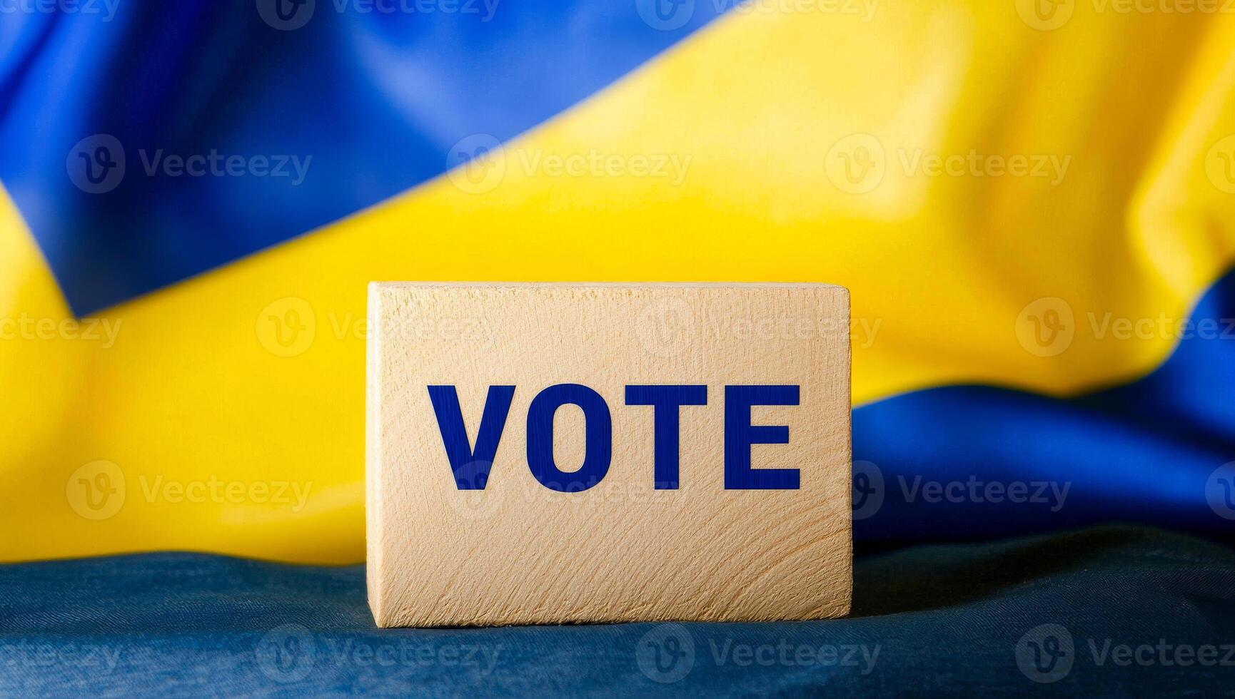 Vote block by Ukrainian flag. A wooden block with VOTE written on it is displayed in front of a Ukrainian flag, symbolizing civic engagement. photo