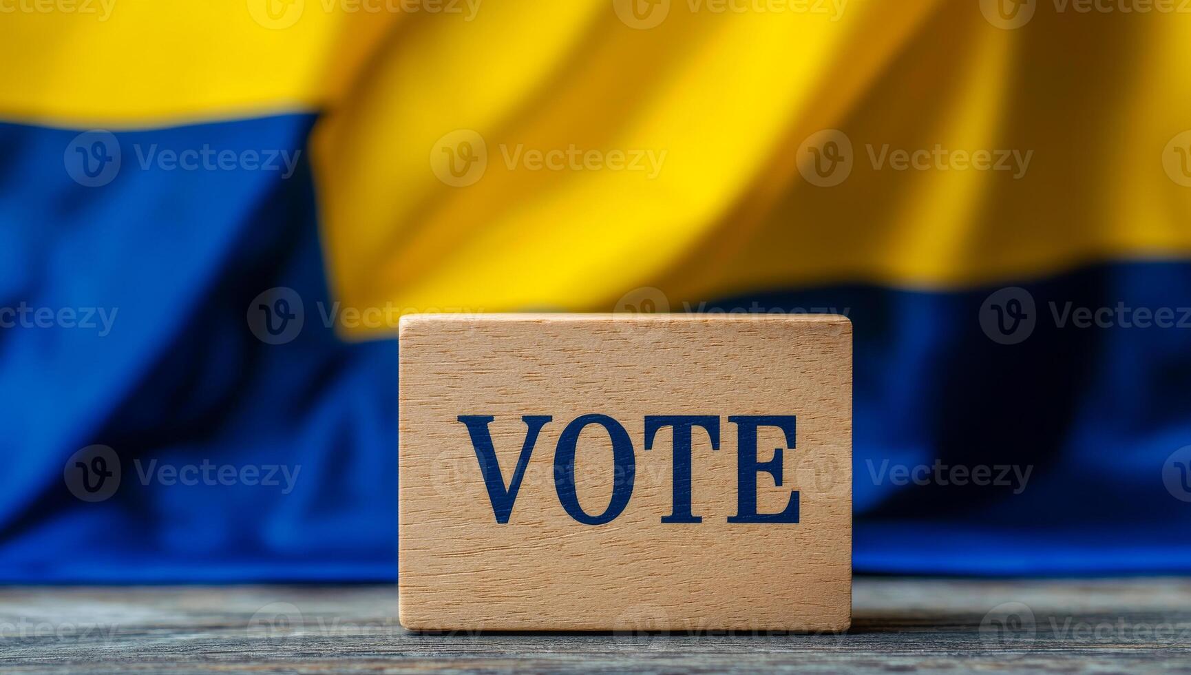 Boosting voting engagement. A wooden block with VOTE is set against a yellow and blue flag, symbolizing democracy. photo