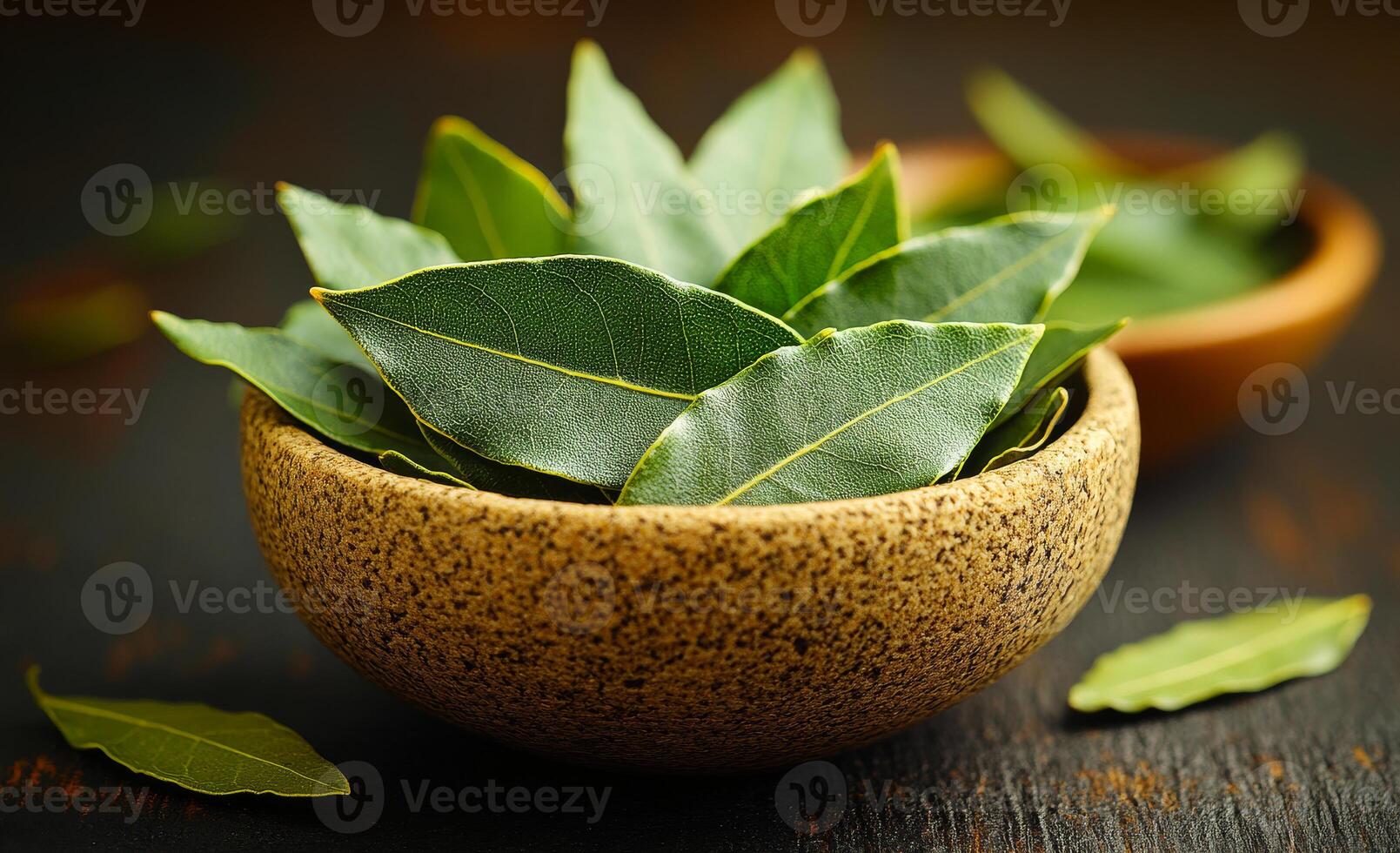 Fresh bay leaves in rustic wooden bowls. Green bay leaves are arranged neatly in natural wooden bowls, showcasing their vibrant color and texture. photo