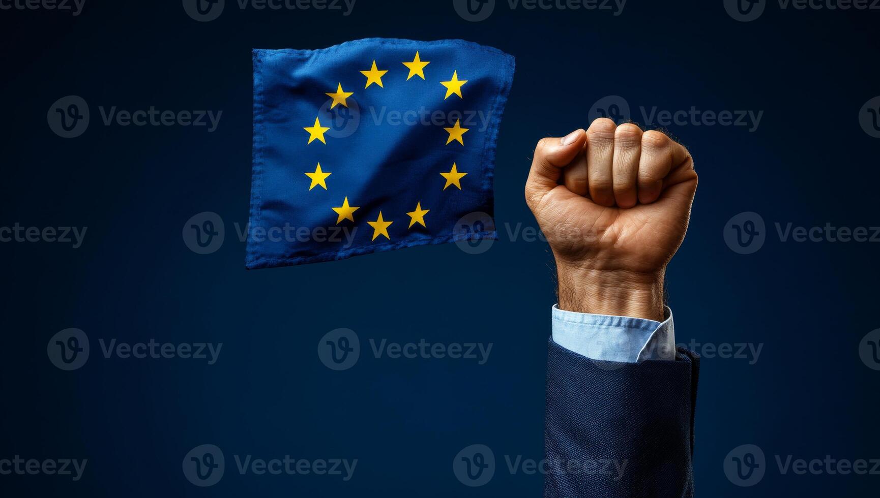 European unity symbolized by raised fist. A hand with a clenched fist holds the European flag against a dark backdrop, representing solidarity and unity. photo