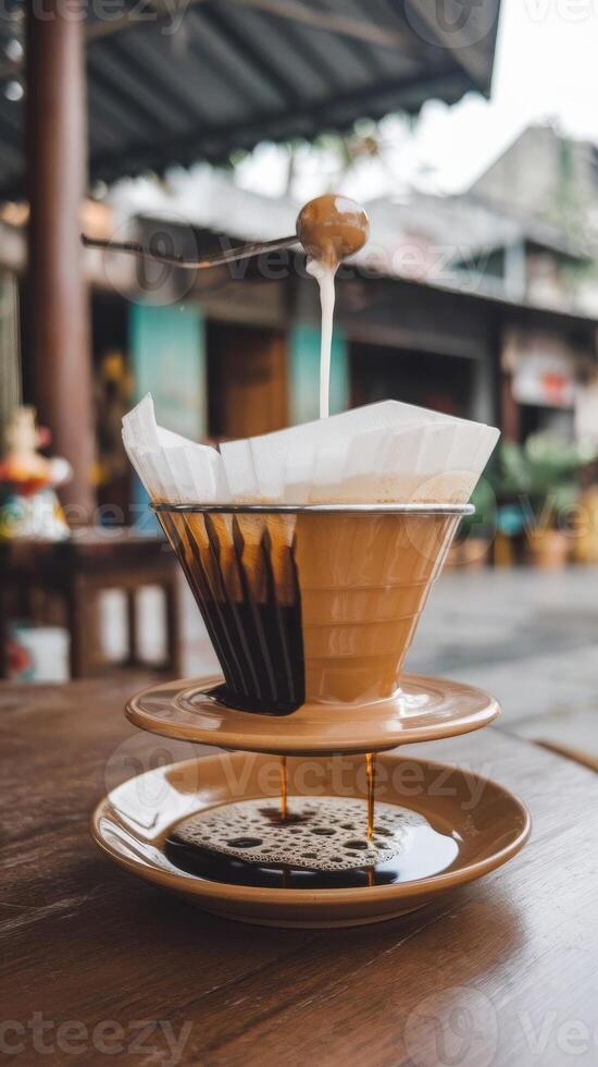 A coffee dripper pouring coffee into a coffee filter photo