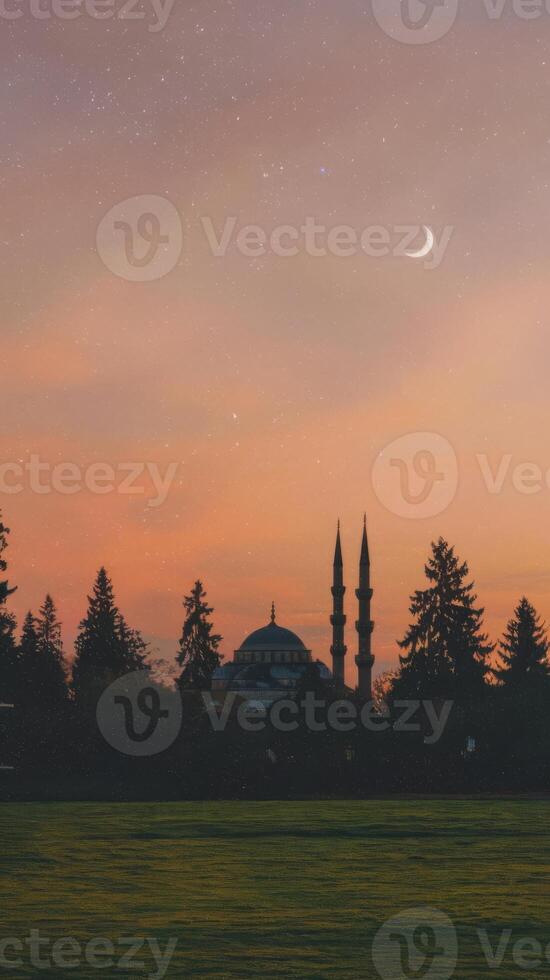A mosque and crescent moon in the sky photo