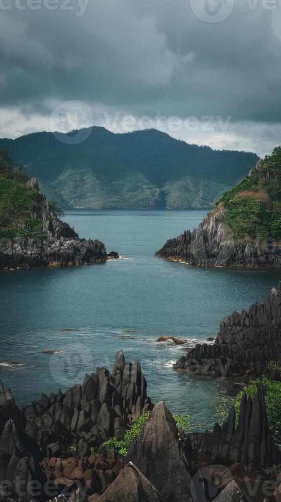 A view of the ocean and mountains from a rocky shore photo