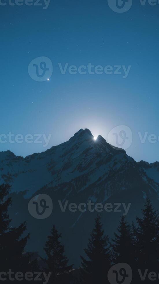 A full moon over a mountain range photo