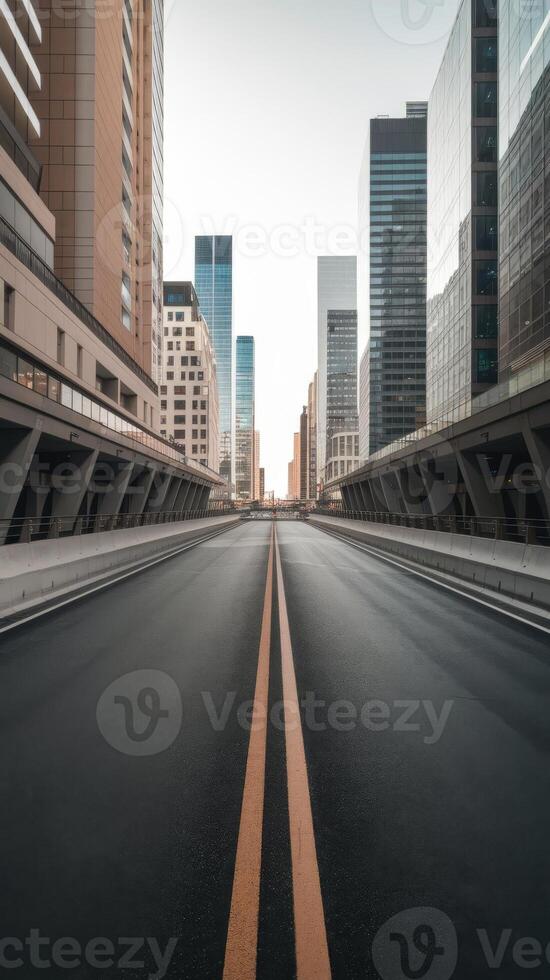 Empty road in the middle of a city with tall buildings photo