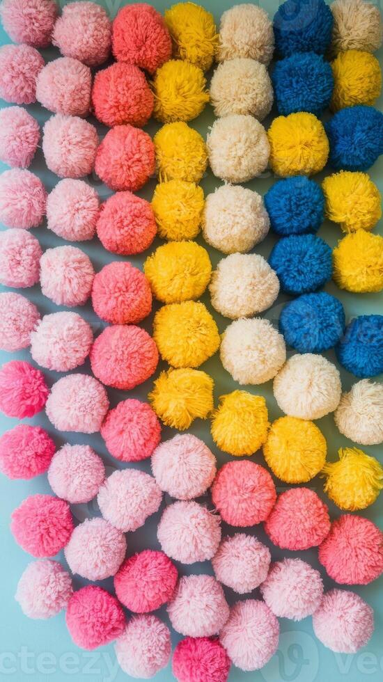 A wall of colorful pom poms on a blue background photo