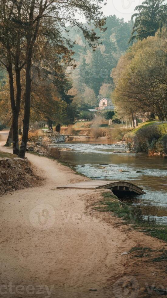 A dirt path next to a river photo