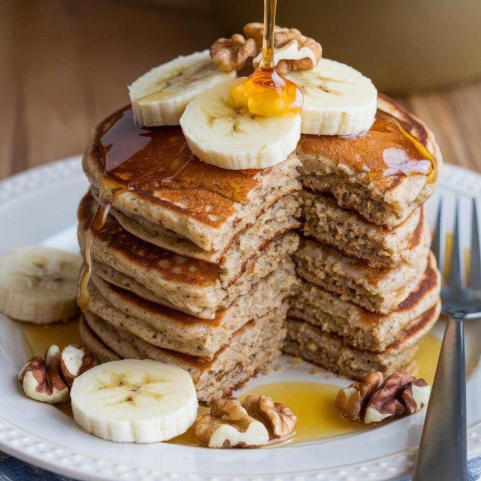 A stack of pancakes with bananas and walnuts photo