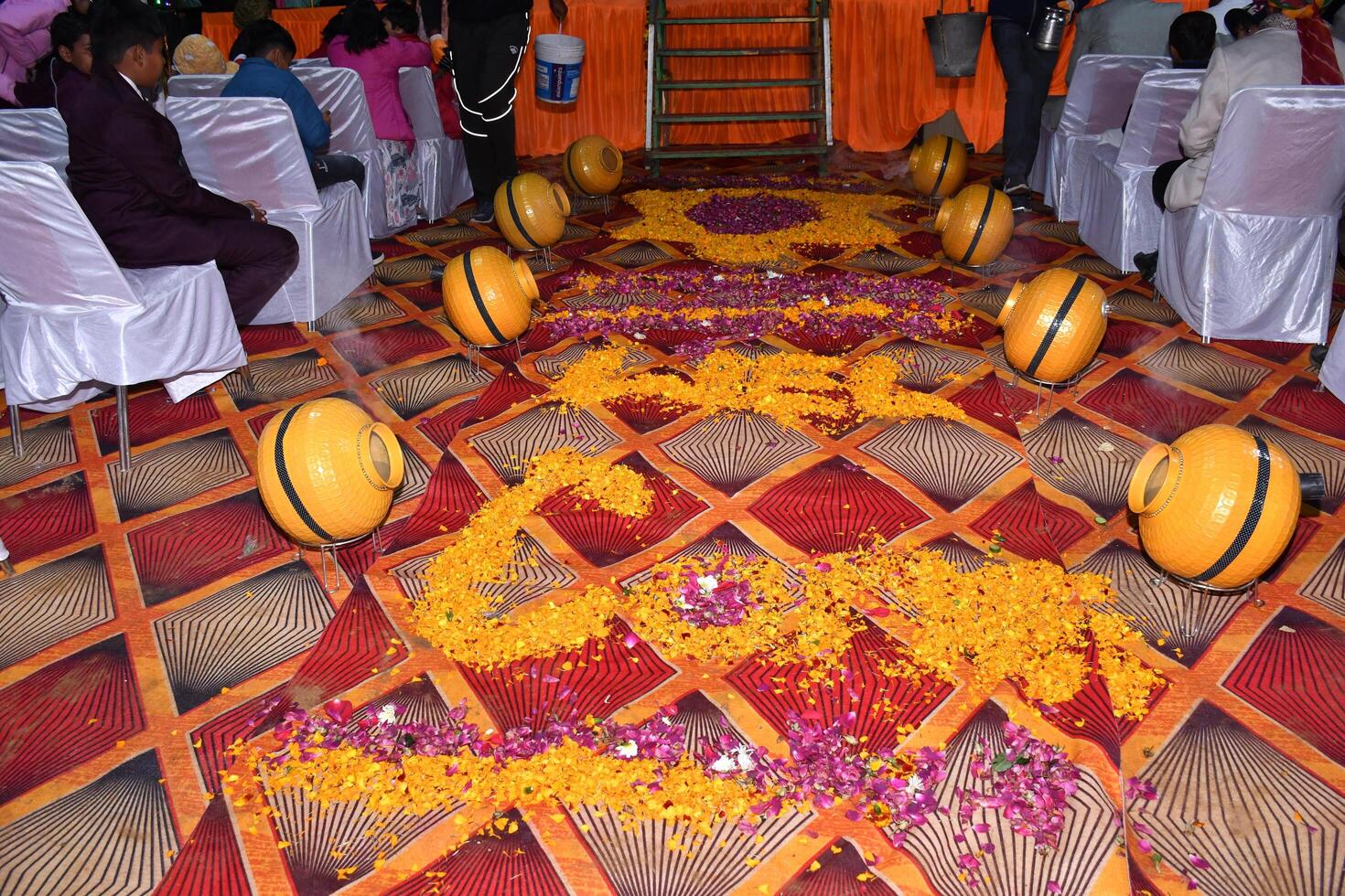 A wedding ceremony with flowers and decorations on the floor photo