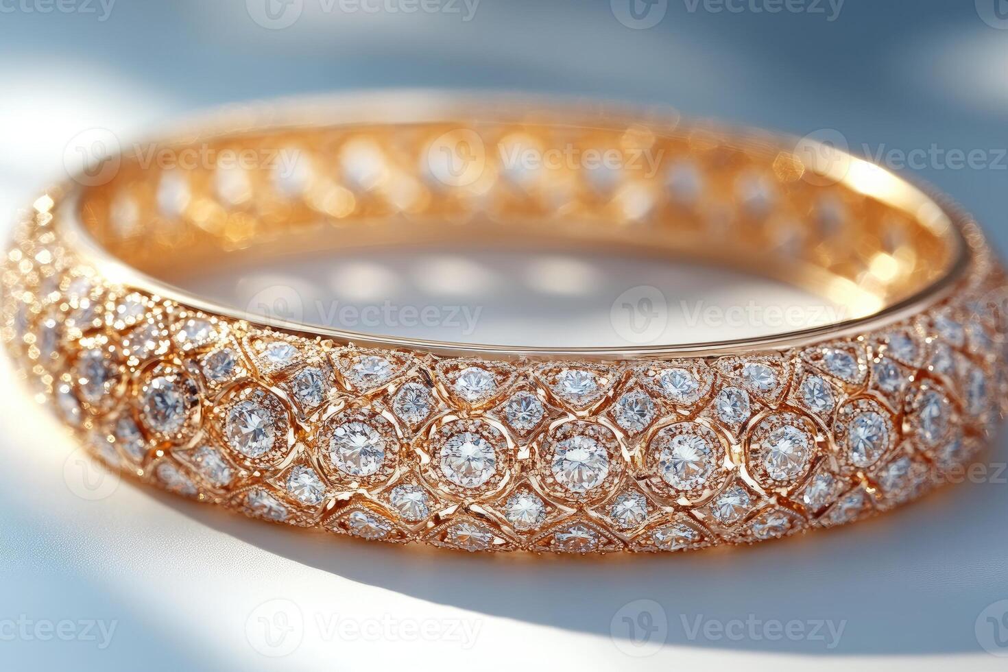 Golden bracelet covered with sparkling diamonds reflecting light photo