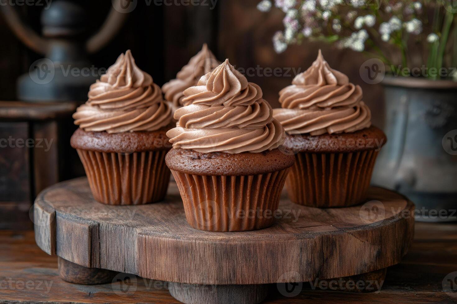 Delicious chocolate cupcakes sitting on wooden cake stand photo