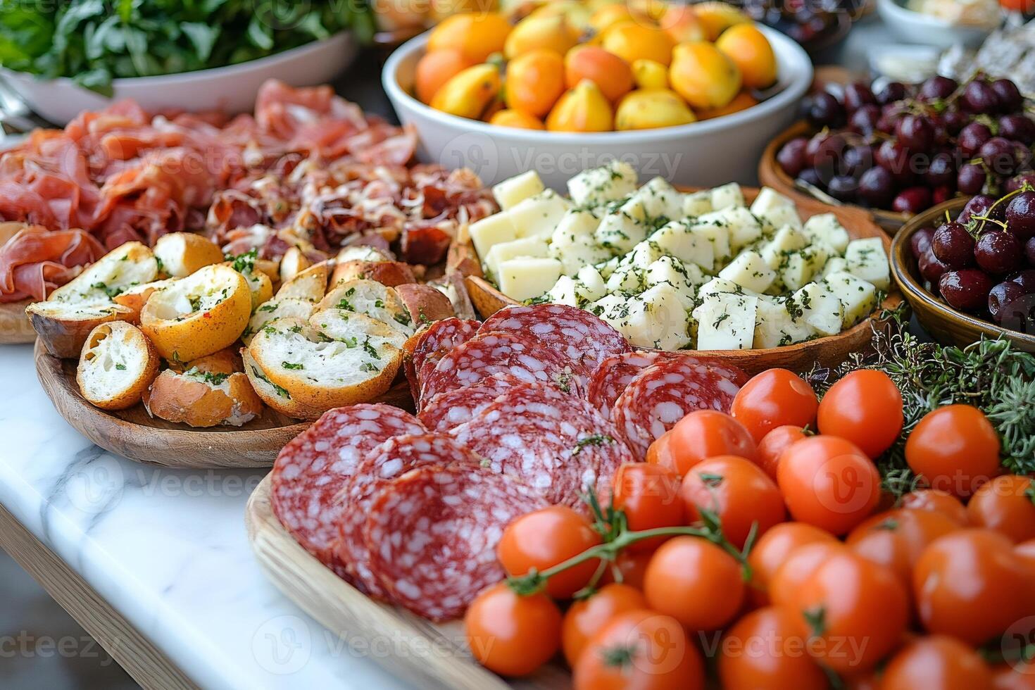 Catering table displaying cured meats, cheese, bread, and cherry tomatoes photo