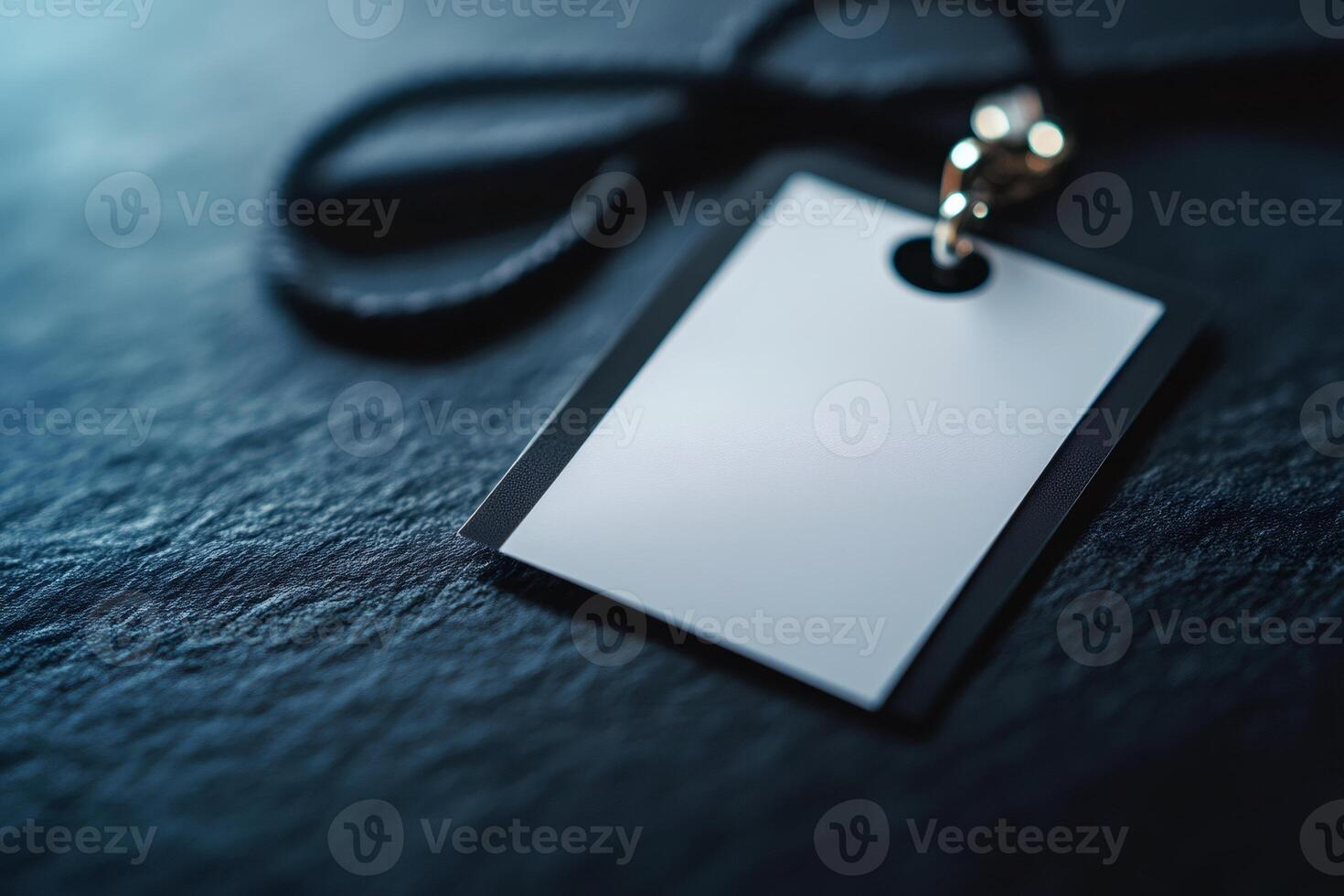 Blank white id card sitting on dark stone surface photo