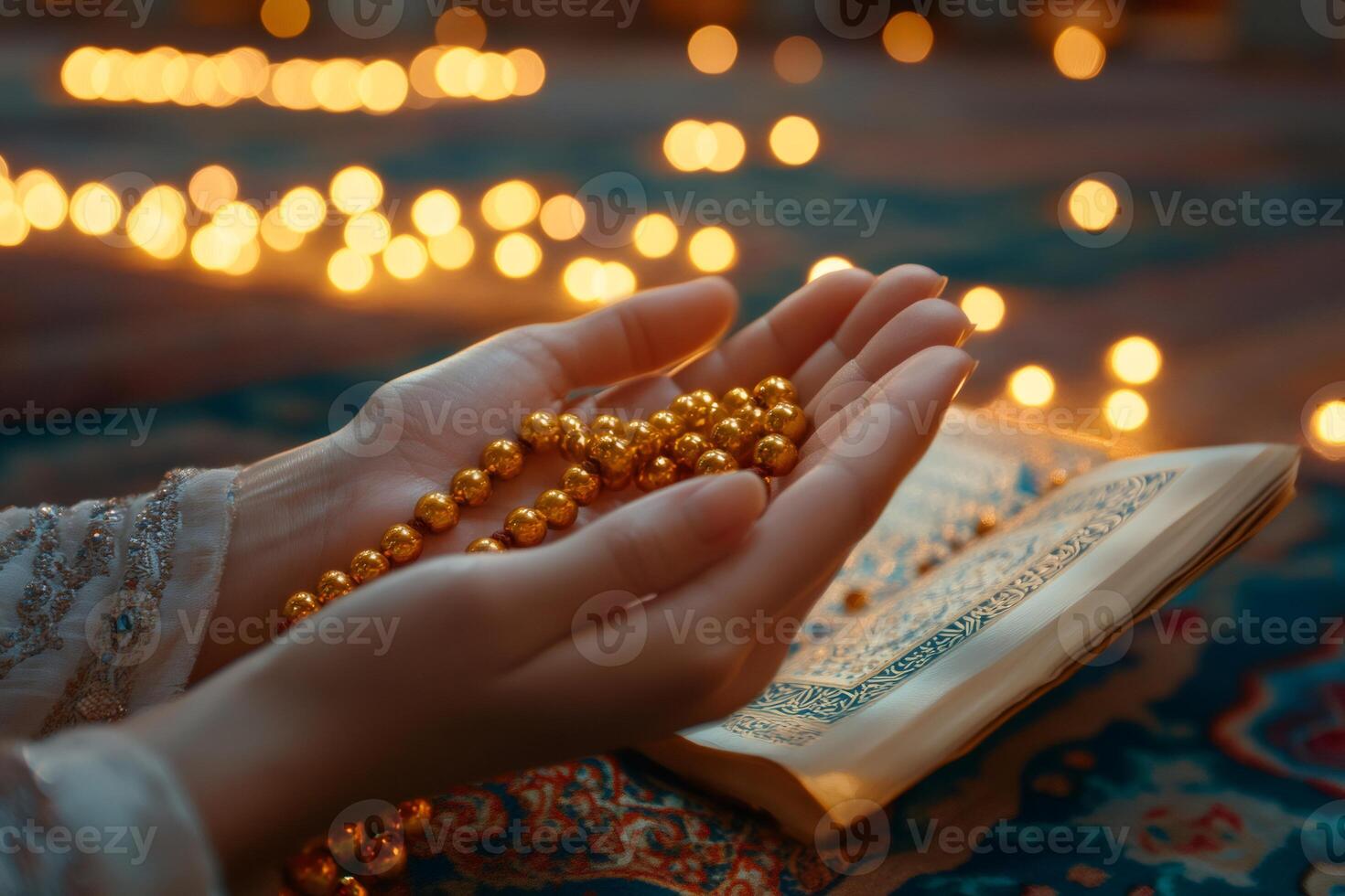 Muslim woman praying with golden rosary beads and holy book in candlelight photo
