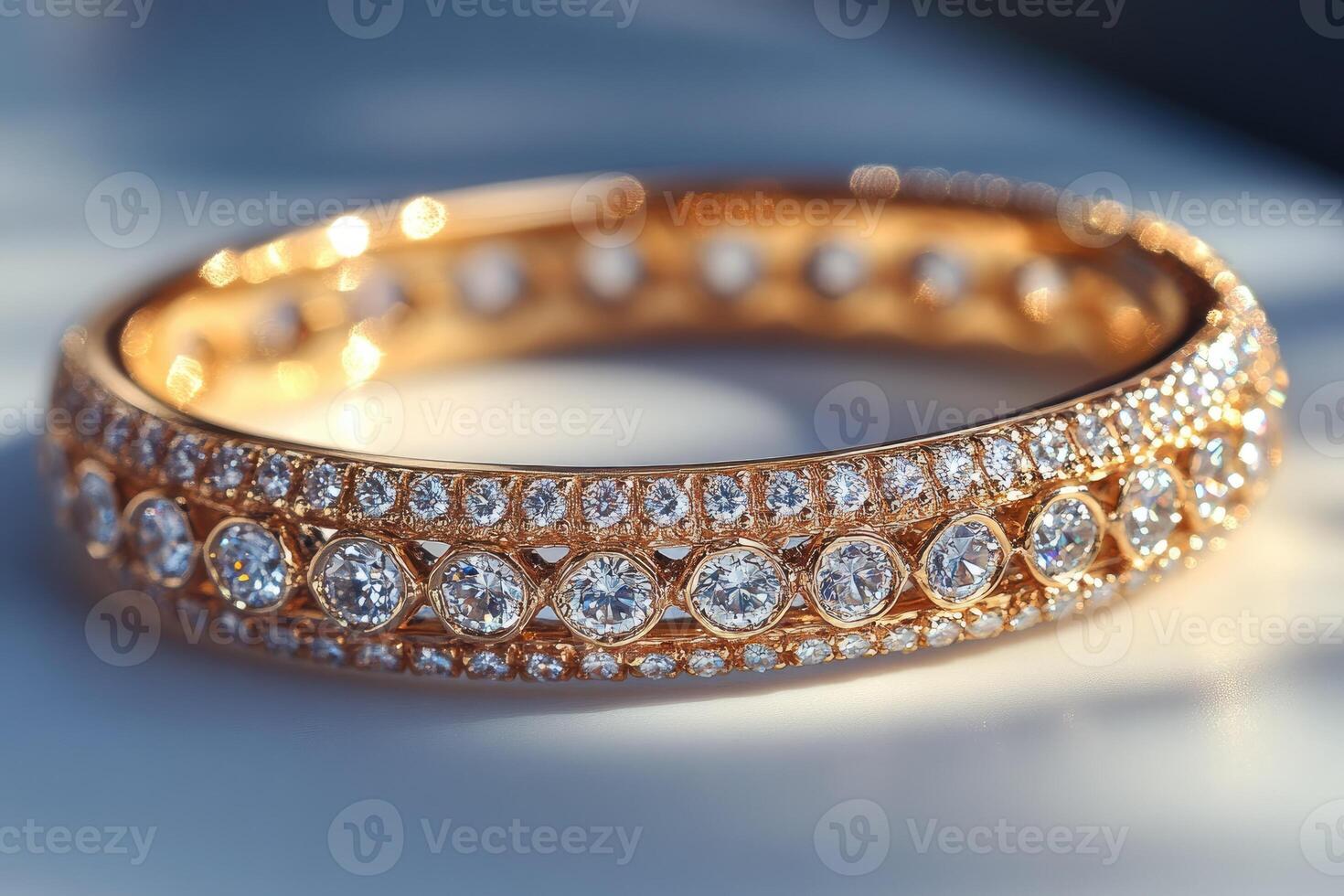 Golden bracelet covered with sparkling diamonds reflecting light.. photo