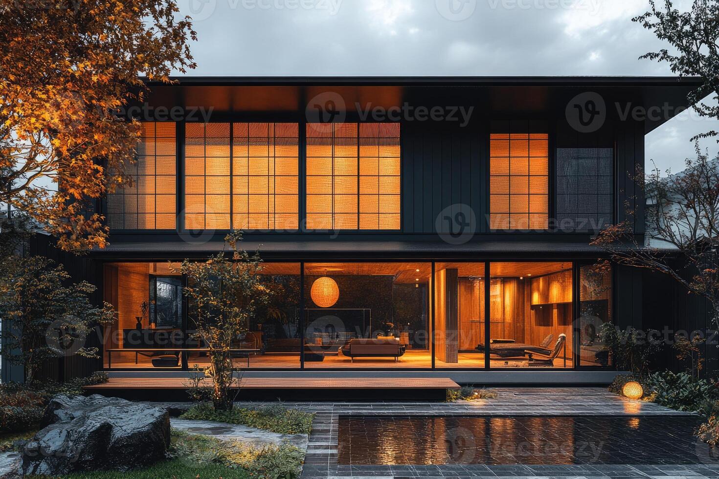 Modern japanese house exterior with illuminated shoji screens at dusk photo