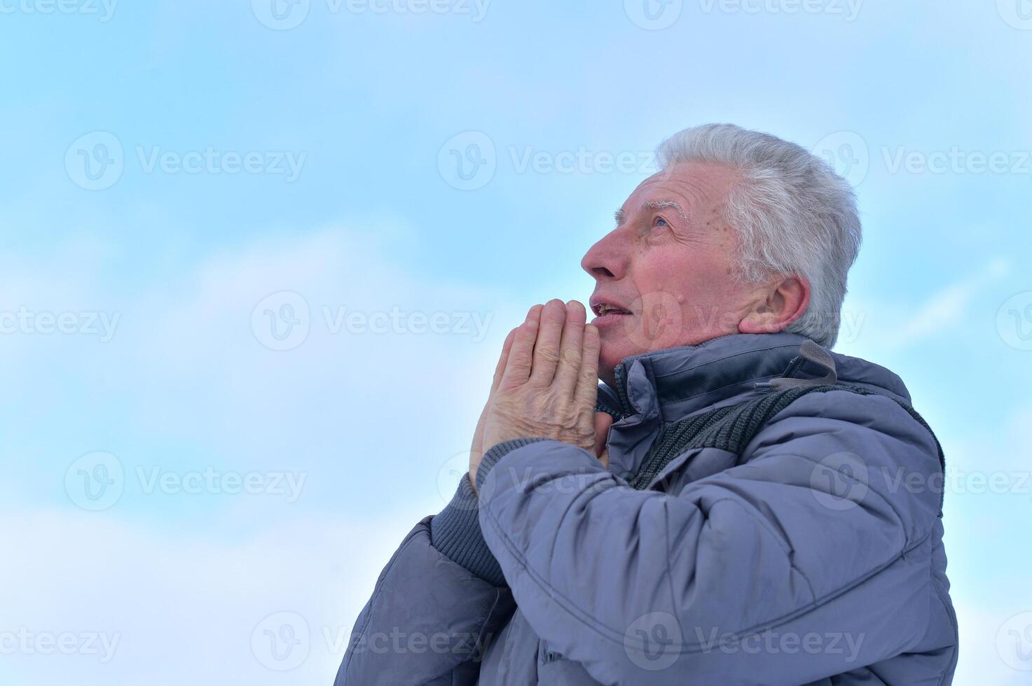 Close up portrait of sad senior man posing outdoors photo