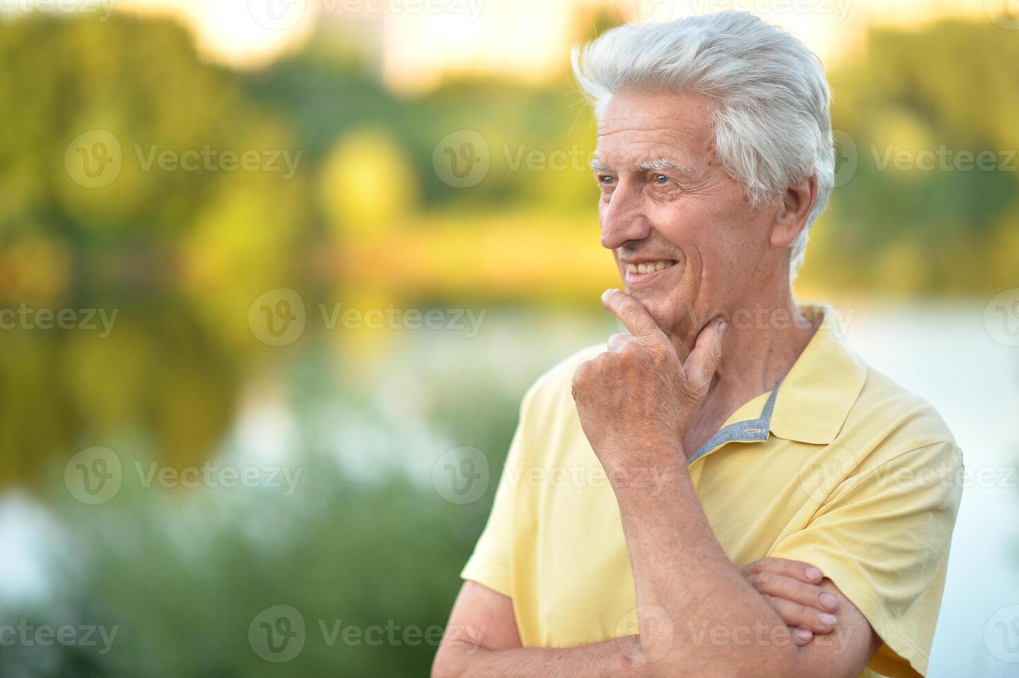 Close up portrait of smiling senior man in park photo