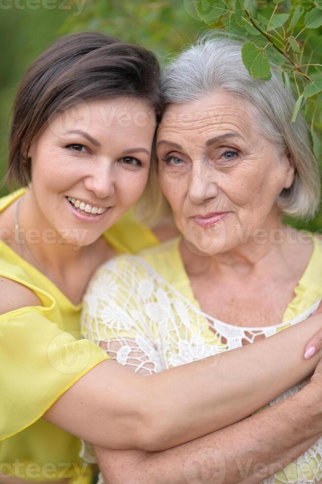 Portrait of an elderly woman with her daughter in the park photo