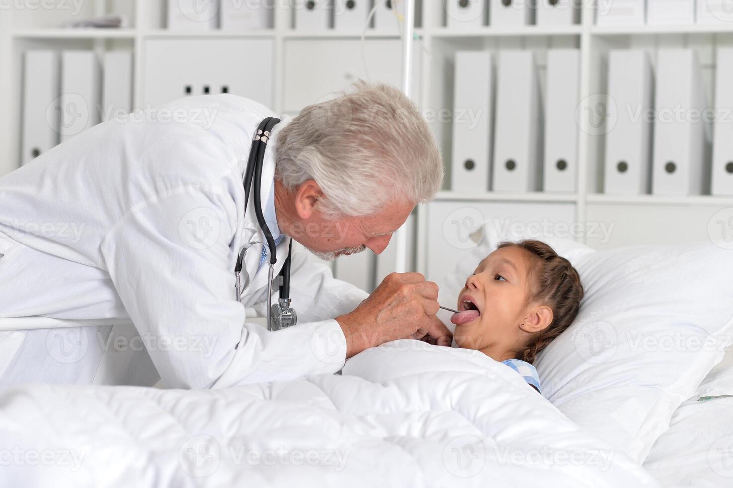 The little girl is in the hospital with a doctor photo