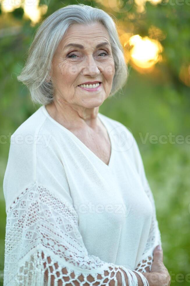 Portrait of a beautiful elderly woman in the park photo
