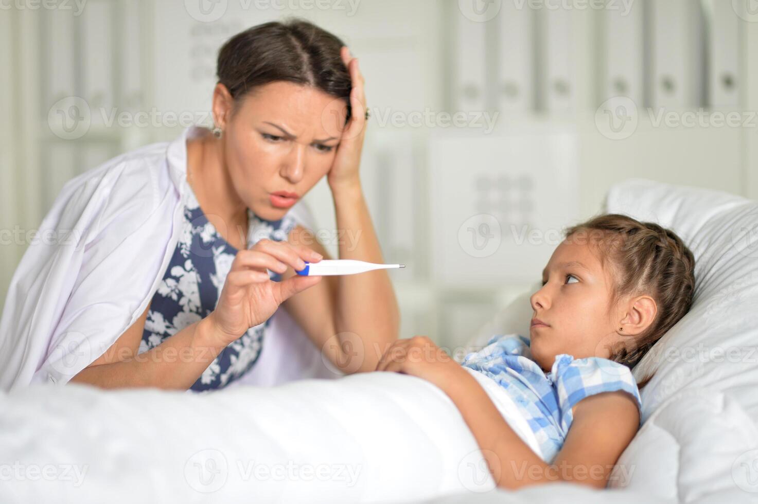 A little girl with her mother in the hospital photo