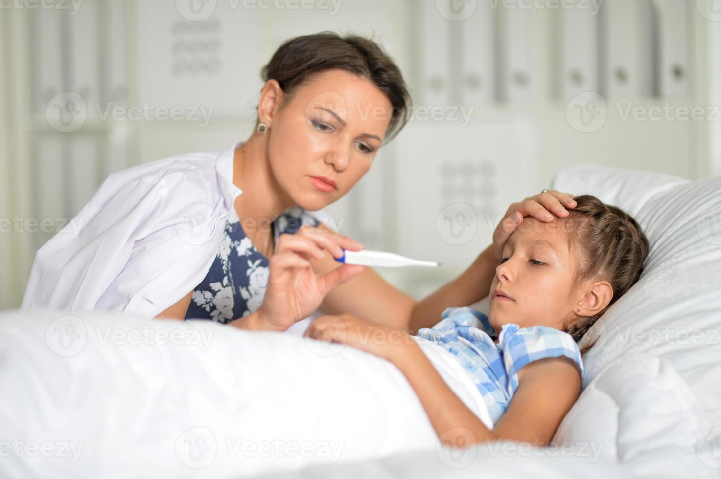 A little girl with her mother in the hospital photo