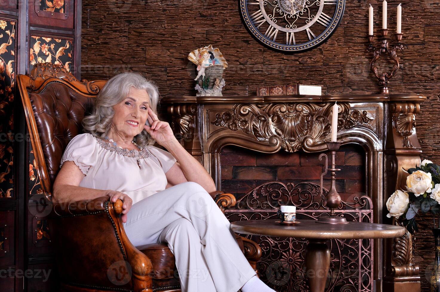 Portrait of happy senior woman posing at home photo