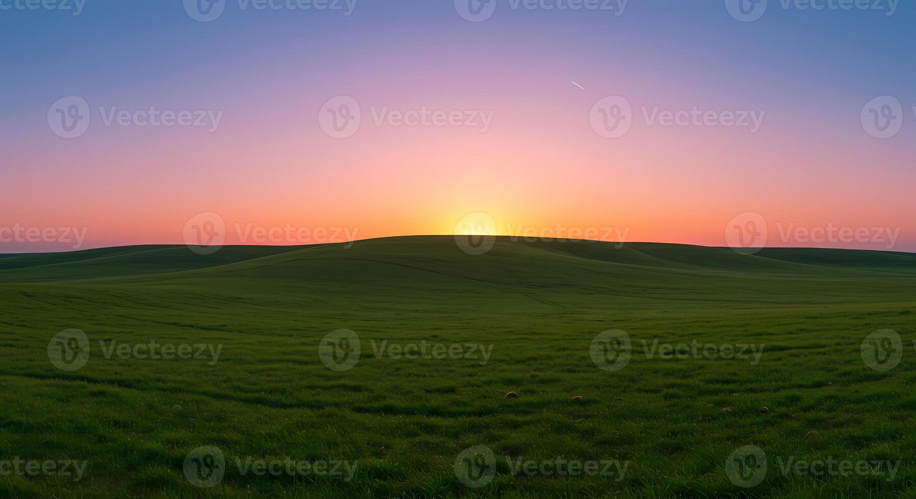a sunset over a green field photo