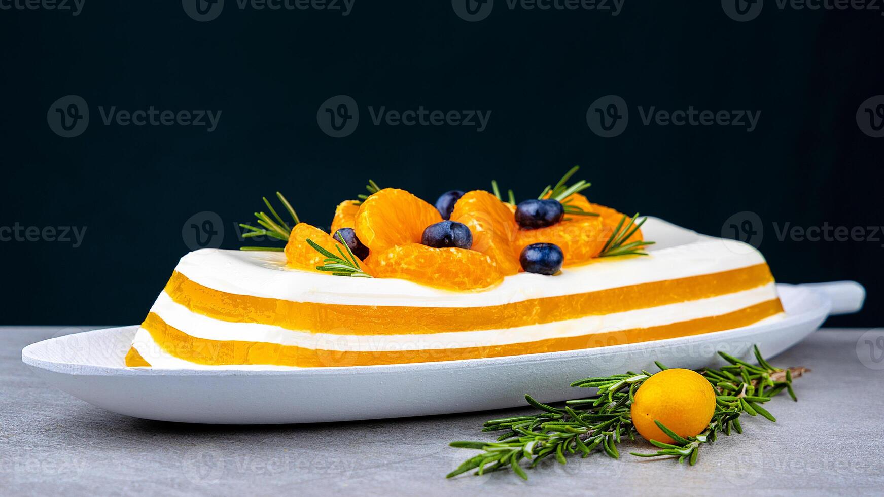 Tangerine or mango panna cotta dessert in glass on a tabletop. Sweet and sour mousse dessert. photo